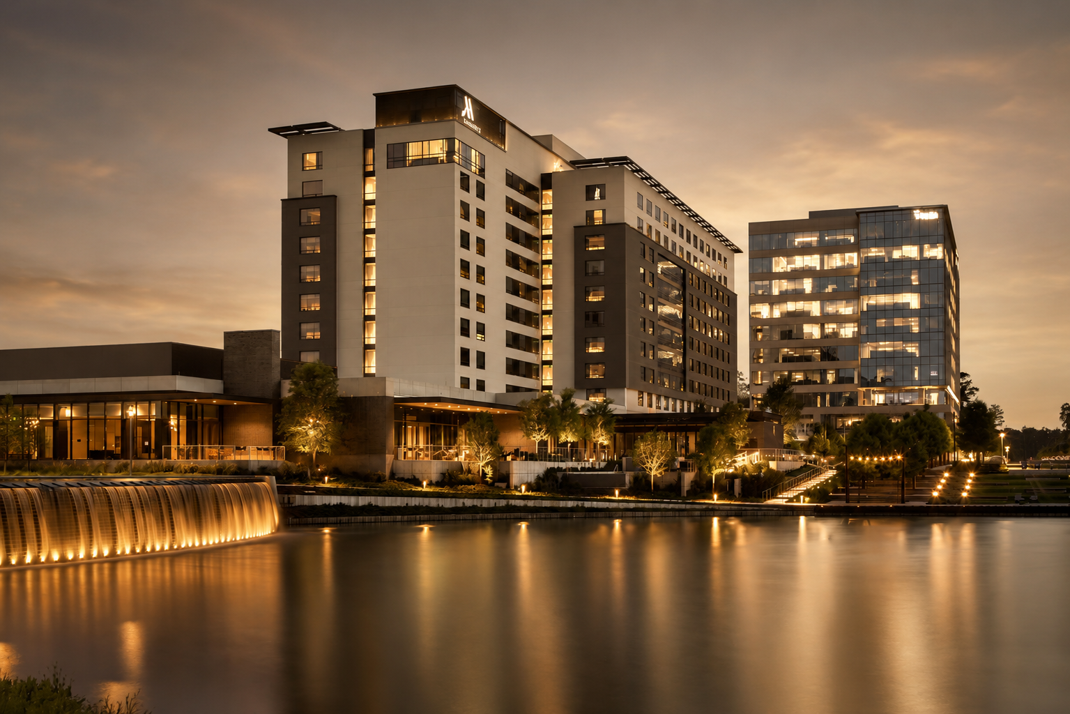 The Houston CityPlace Marriott at Springwoods Village above the lake at dusk