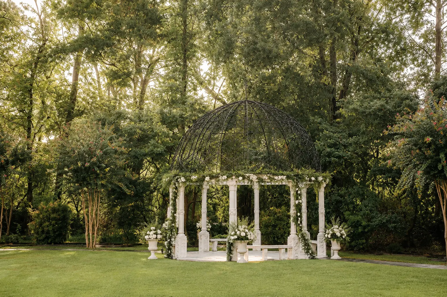 The garden gazebo at Chateau Nouvelle dressed with white florals and greenery in winter daylight